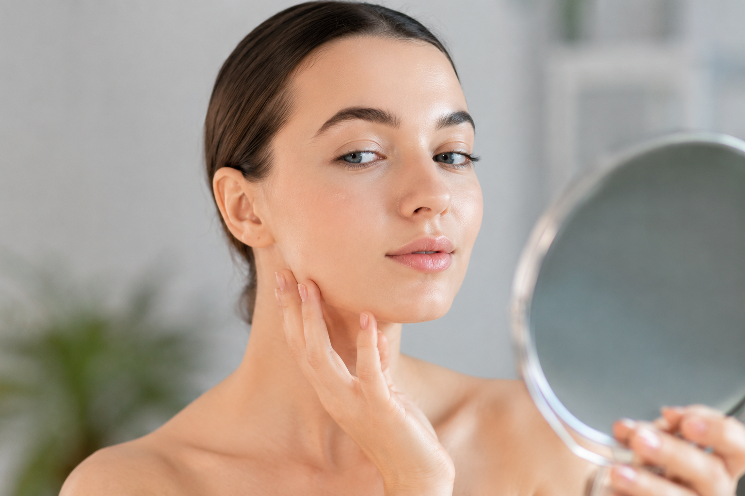 Woman checking natural facial balance after cosmetic filler treatment at a Tokyo aesthetic clinic.